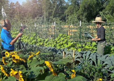 Spectrum 13 reporting standing in produce field with Farmer Nicole